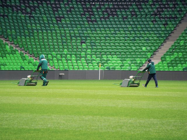 Mowing grass in a football stadium